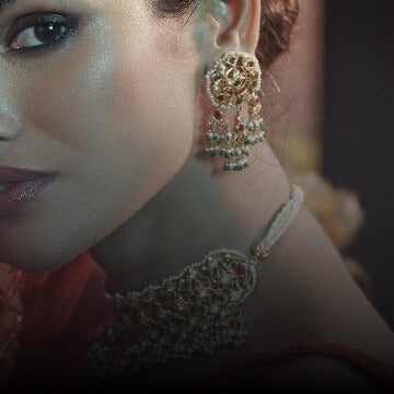 Kundan set in 22kt gold with semi-precious green & red gemstones & pearls