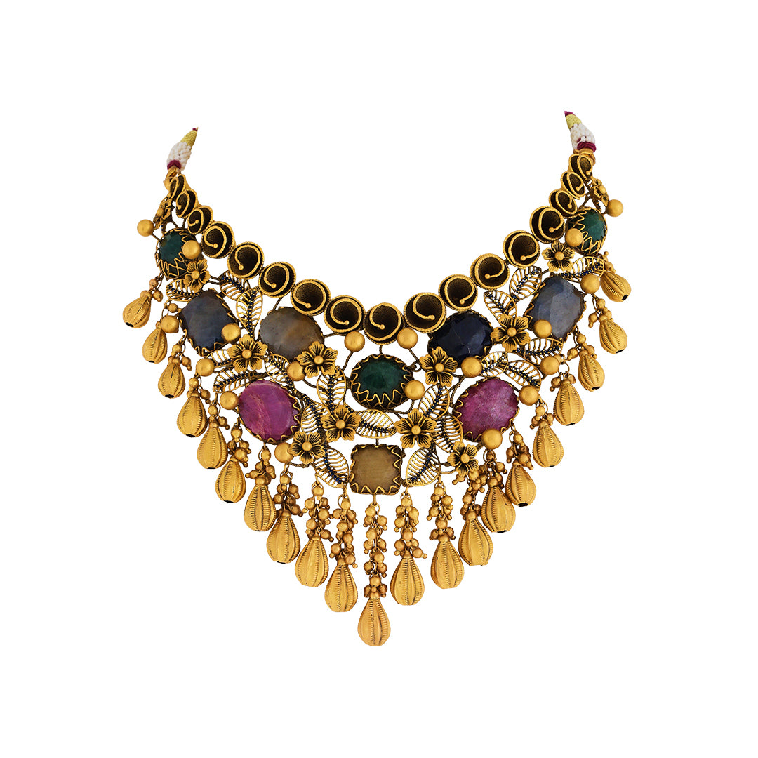 Necklace set in 22kt antique gold with emerald, ruby, and blue sapphire.